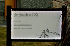 The sign for The Church at FOX fully lit up